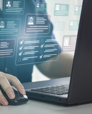 En person som använder en datormus och en bärbar dator.