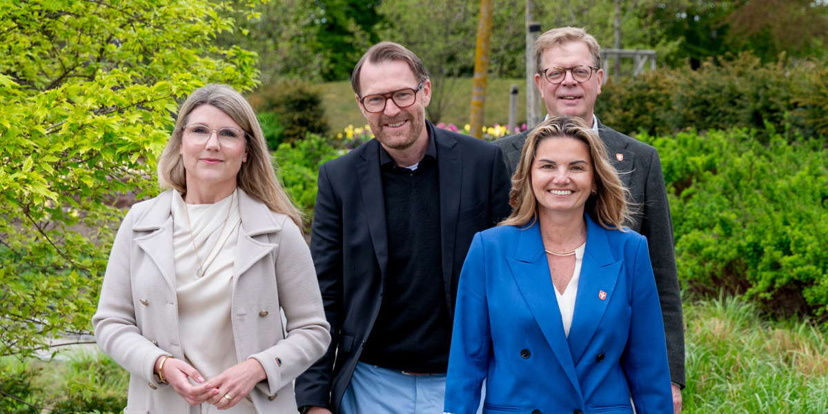 En grupp människor som går längs en trottoar.