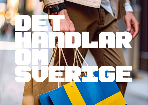 En man som bär en shoppingväska med en flagga på.