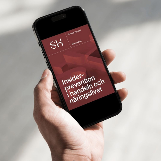 En person som håller en mobiltelefon i handen.