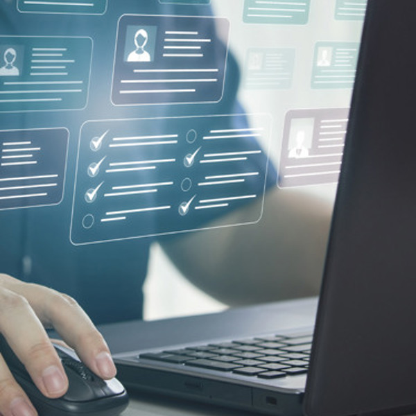 En person som använder en datormus och en bärbar dator.