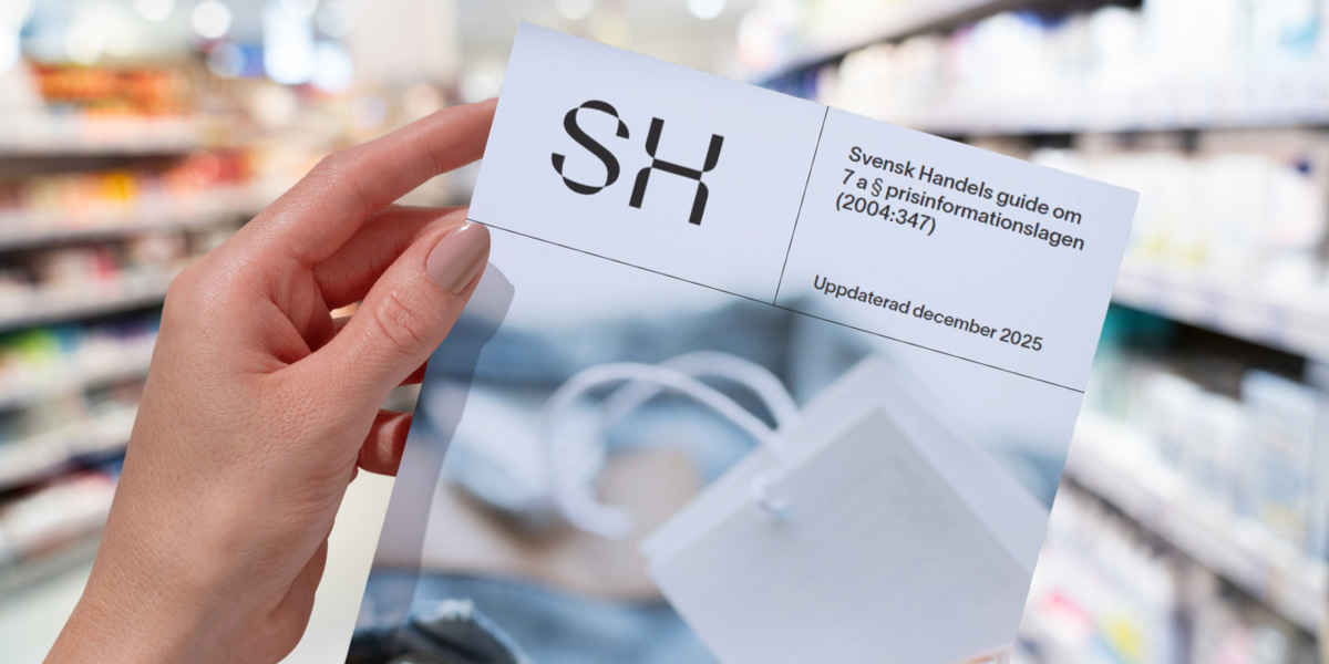 En person som håller upp ett visitkort i en butik.