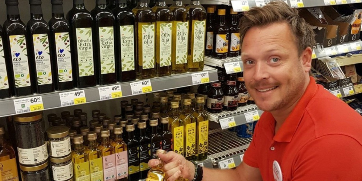 En man som håller en vinflaska i en butik.