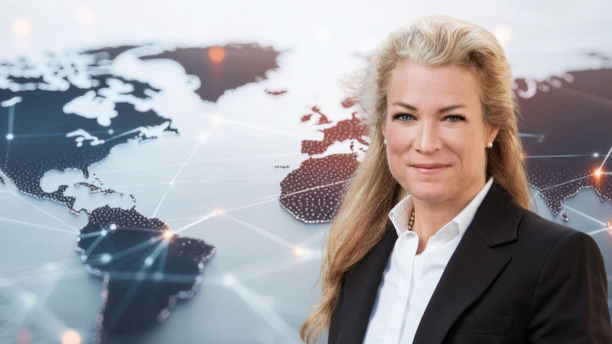 En kvinna står framför en världskarta.