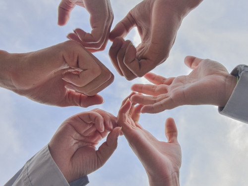 flera händer i luften