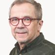 En man med glasögon och en grön skjorta.